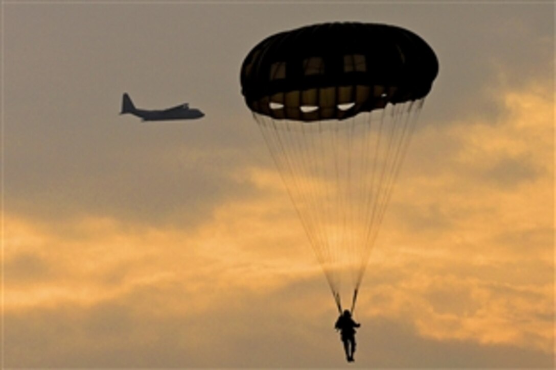 A U.S. paratrooper conducts airborne operations from a U.S. Air Force C-130 Hercules over Hopfenohe Drop Zone at the 7th Army Joint Multinational Training Command's Grafenwoehr Training Area, Germany, Sept. 25, 2013. The paratroopers are assigned to Special Operations Command Africa.
