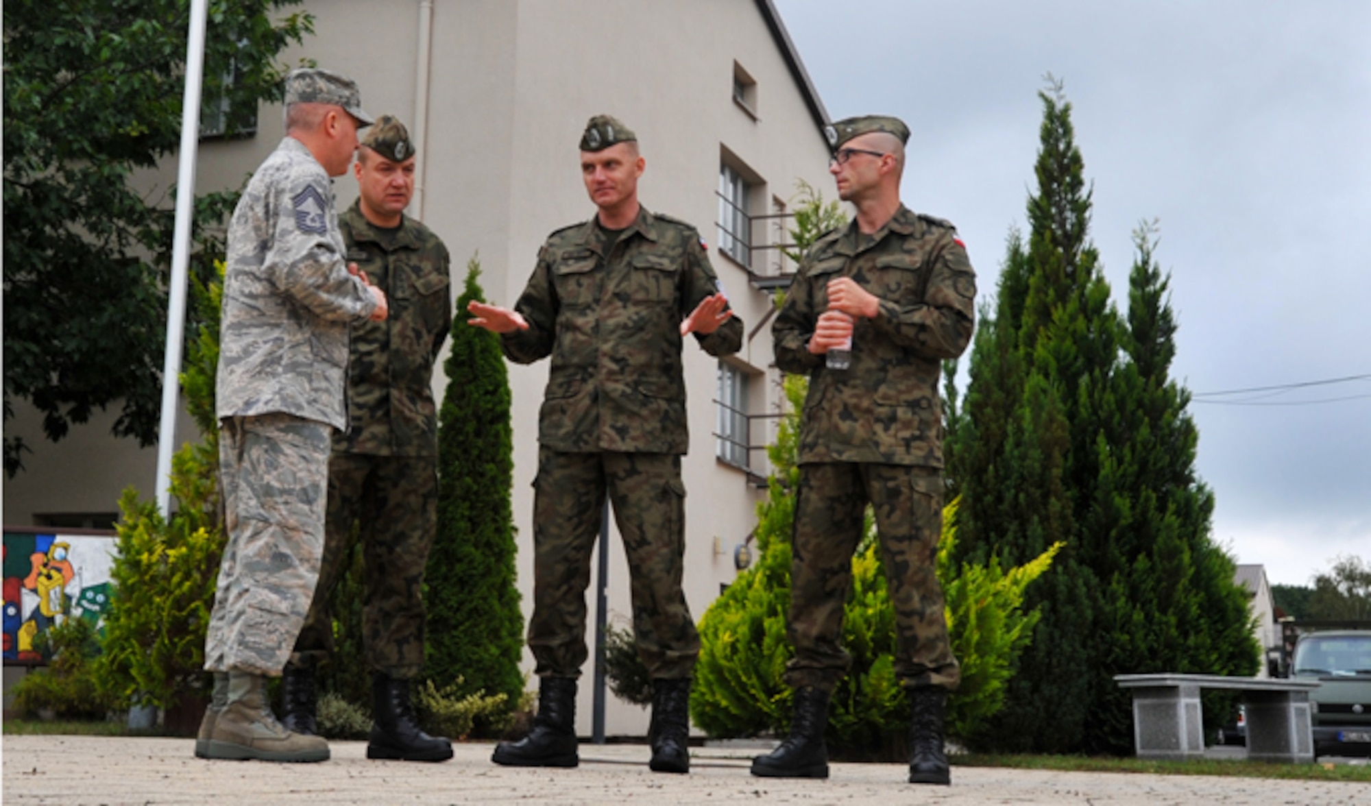 Chief Master Sgt. Christopher Moore (far left), Kisling NCO Academy commandant, gives a tour to Warrant Officer 1st Class Krzysztof Gadowski (second from right) and his staff Sept. 17, 2013, at Kapaun Air Station, Germany. The visit gave the Polish senior NCO leaders a chance to further military relations and improve military education programs for Polish airmen.
