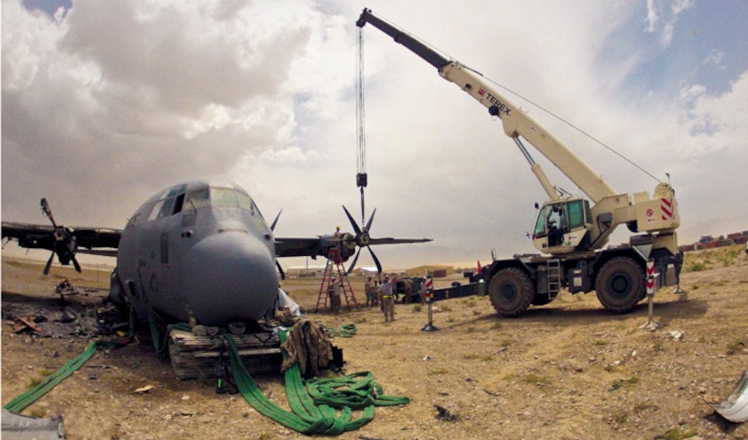 Airmen forward deployed from the 379th Air Expeditionary Wing assist in a crash damage reclamation and demilitarization project of a C-130J Super Hercules July 1, 2013, at a forward operating base in Afghanistan. The team recovered 250 components totaling more than $20 million.