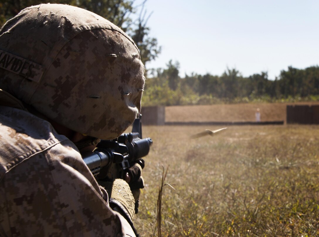 Sgt. Eduardo L. Benavides, a combat instructor with The Basic School, fires from the prone position at a Robotic Moving Target during the Moving Target Technique Limited Objective Experiment 2 at Marine Corps Base Quantico, Va., Sept. 24, 2013. Marines from The Basic School and Weapons Training Battalion tested techniques using semi-automatic, burst, and automatic fire in the standing, kneeling and prone positions. The experiment tests the most effective technique and method to engage moving targets with the M-4 carbine and M-27 infantry automatic rifle.  