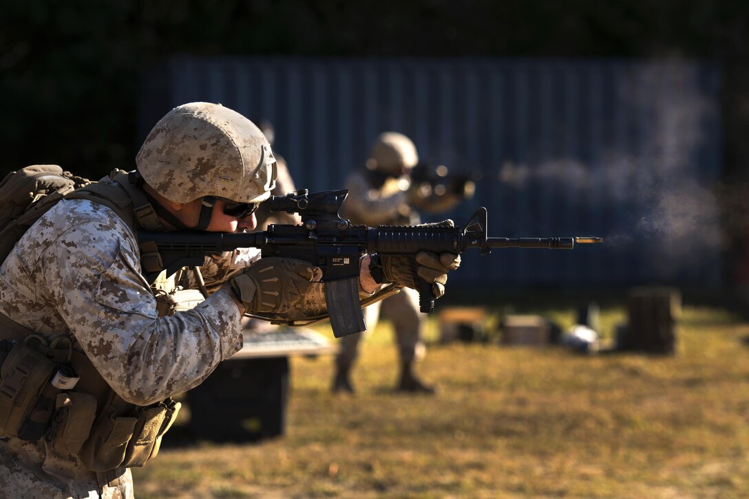 Sgt. Jeremy T. Wellenreiter, a primary marksmanship instructor with Weapons Training Battalion, fires an M-4 Carbine at Robotic Moving Targets at Marine Corps Base Quantico, Va., Sept. 24, 2013. The Marines were part of a test group to help determine the most effective marksmanship technique and method for infantrymen to engage moving personnel targets. (U.S. Marine Corps photo by Cpl. Daniel Wetzel/Released)