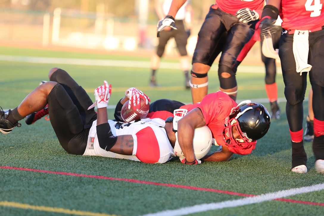 Antoino Hayden, Marine Corps Air Station Miramar defensive back, wraps up 7th Engineer Support Battalion Engineer's runningback during a Falcon's victory at Paige Field House aboard Marine Corps Base Camp Pendleton, Sept. 24. The Falcon's season record improves to 5-0 after the win.