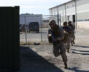 Sailors with 2nd Medical Battalion, 2nd Marne Logistics Group run toward the sound of chaos during the Tactical Combat Casualty Care/Combat Lifesaver course aboard Camp Lejeune, N.C., September 26, 2013. The students ran into a building, cleared rooms in teams, and provided care to casualties as part of the practical application portion of the course. (U.S. Marine Corps photo by Lance Cpl. Shawn Valosin)