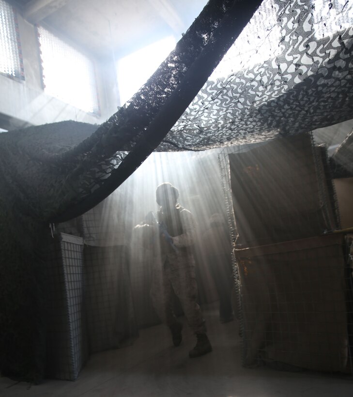 A Corpsman with 2nd Medical Battalion, 2nd Marine Logistics Group enters the “Kill House” during the Tactical Combat Casualty Care/Combat Lifesaver course aboard Camp Lejeune, N.C., September 26, 2013 Once in the house, students encountered near darkness, strobe lighting, and loud noises while finding and treating simulated casualties. (U.S. Marine Corps photo by Lance Cpl. Shawn Valosin)