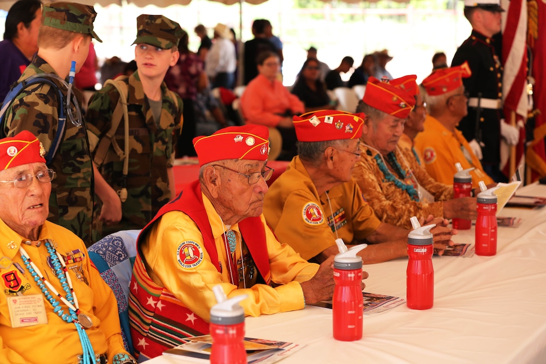 Navajo Code Talkers, Marine Corps veterans from World War II, sit patiently as the color guard, Marines with 4th Reconnaissance Battalion in Albuquerque, N.M., begin to post the colors during the Navajo Code Talkers Day ceremony, Aug. 14, at Veterans Memorial Park, Window Rock, Ariz.
