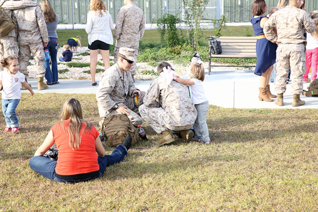Marines with 2nd Explosive Ordnance Disposal Company, 8th Engineer Support Battalion, 2nd Marine Logistics Group spend time with their families and friends at the EOD Headquarters building before deploying to Afghanistan aboard Camp Lejeune, N.C., Sept. 26, 2013. Family, friends and fellow comrades came to visit the service members before departing overseas.