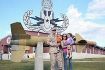 Staff Sgt. Ian P. Hassing, an Explosive Ordnance Disposal technician with 2nd EOD Company, 8th Engineer Support Battalion, 2nd Marine Logistics Group, poses with his family at the 2nd EOD headquarters building aboard Camp Lejeune, N.C., Sept. 26, 2013. Service members played with their sons and daughters at the compound before stepping onto a bus on their way to Afghanistan. 