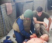 Petty Officer Third Class Joshua O’Hara (right) evaluates a student during the Tactical Combat Casualty Care/Combat Lifesaver course aboard Camp Lejeune, N.C., September 26, 2013. The course brought battlefield stressors to the classroom to ensure that service members were prepared to save lives in a deployed environment. (U.S. Marine Corps photo by Lance Cpl. Shawn Valosin)