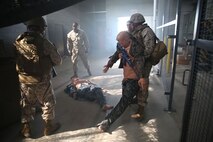 Sailors with 2nd Medical Battalion, 2nd Marine Logistics Group evacuate a trauma victim during the Tactical Combat Casualty Care/Combat Lifesaver course aboard Camp Lejeune, N.C. September 26, 2013. During the course, students experienced mental and physical stress to simulate a combat environment.  (U.S. Marine Corps photo by Lance Cpl. Shawn Valosin)