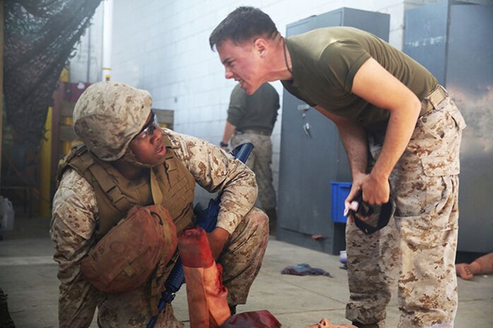 Petty Officer Third Class Joshua O’Hara (right) yells at a student about proper tourniquet placement during the Tactical Combat Casualty Care/Combat Lifesaver course aboard Camp Lejeune, N.C., September 26, 2013. Shouting, explosions, and loud sound effects were just a few of the tools the TCCC/CLS course utilized to bring the stress of the battlefield to a classroom environment. (U.S. Marine Corps photo by Lance Cpl. Shawn Valosin)