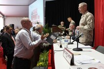 Industry representatives talk with panel members including Lt. Gen. Kenneth Glueck Jr. (foreground), deputy commandant for Combat, Development and Integration, before the Report to Industry Sept. 26 at the Modern Day Marine Military Exposition on Marine Corps Base Quantico, Va. The panel discussion offered insights from key Marine senior officers to companies exhibiting at the expo.