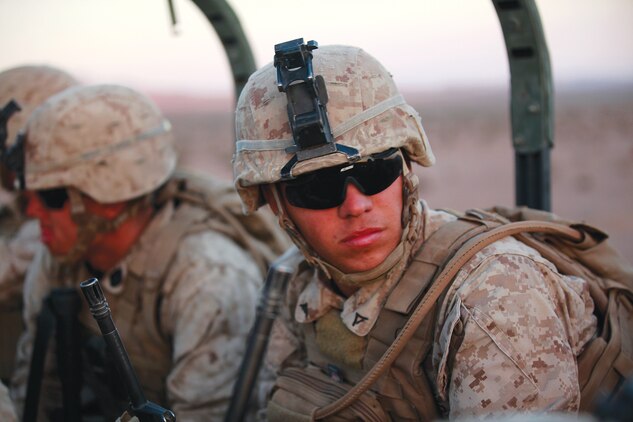 A Marine with Fox Company, 2nd Battalion, 3rd Marine Regiment, waits in the back of a 7-ton vehicle to start the assault on an objective during a dry run exercise of the battalion assault course, Sept. 15, 2013 at the Marine Corps Air Ground Combat Center, Calif., training area. The battalion has been conducting the combat center's Integrated Training Exercise since Aug. 18 and will be returning home soon. (U.S. Marine Corps photo by Cpl. Sarah Dietz)