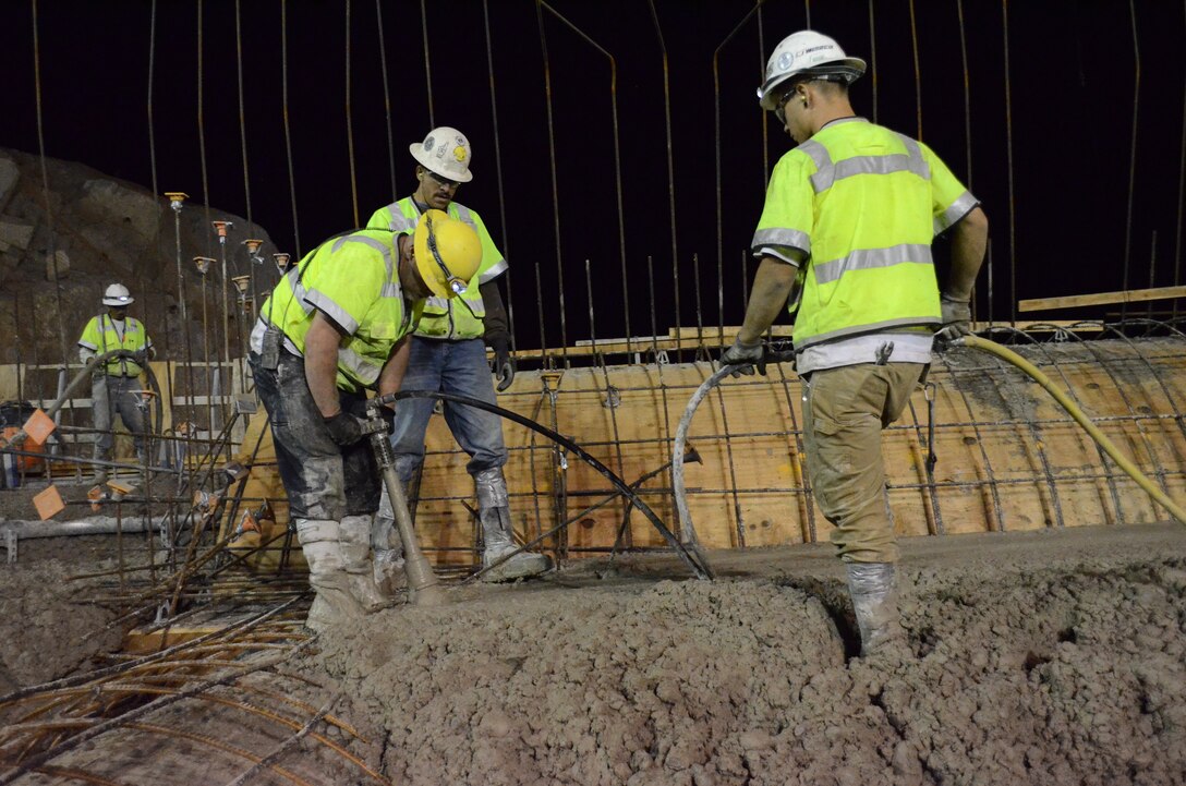 Workers settle concrete atop the Folsom Dam auxiliary spillway’s new control structure July 26, 2013 in Folsom, Calif. Concrete is placed at night in 5-feet-deep layers called lifts. The concrete must cure for up to three weeks before another section can be placed