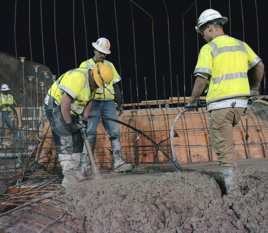 Workers settle concrete atop the Folsom Dam auxiliary spillway’s new control structure July 26, 2013 in Folsom, Calif. Concrete is placed at night in 5-feet-deep layers called lifts. The concrete must cure for up to three weeks before another section can be placed. 