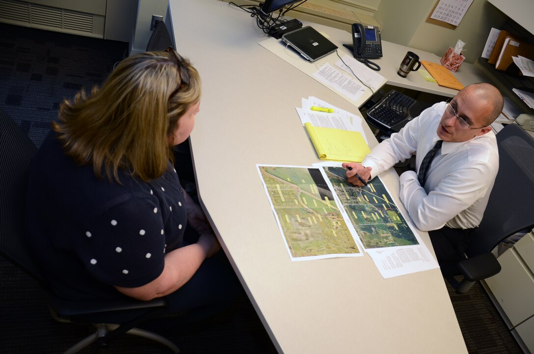 Bonnie Greenleaf, left, project management, and Damon Roberts, counsel, look over maps of the Devils Lake, N.D., area that identifies constructed embankments and as well as adjacent landowners.