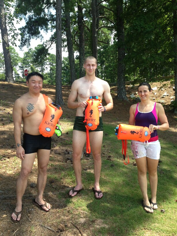 From left to right: Tri-Augusta members Collin Koch, John Lesko and Anne Cecile Huby hold swim buoys, which help increase swimmers visibility on the water. The group teaches safe swimming practices to athletes and members of the public surrounding the U.S. Army Corps of Engineers' J. Strom Thurmond Lake.