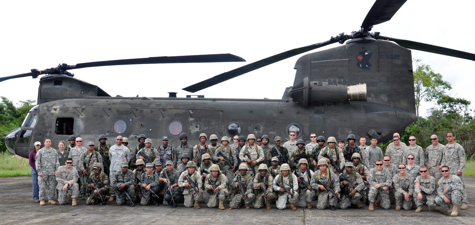 Members of Joint Task Force-Bravo and members of the Belizean armed forces pose in front of one of Joint Task Force-Bravo's CH-47 Chinook helicopter's prior to a training exercise in Belize, Sept. 26, 2013.  Joint Task Force-Bravo and the Belizean military performed joint military training in order to enhance operational capabilities as well as to continue to build international relationships.  (U.S. Air Force photo by Capt. Zach Anderson)