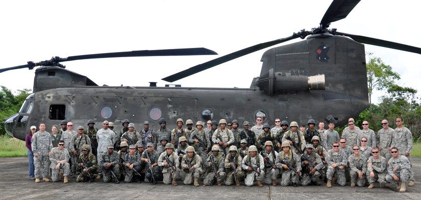 Members of Joint Task Force-Bravo and members of the Belizean armed forces pose in front of one of Joint Task Force-Bravo's CH-47 Chinook helicopter's prior to a training exercise in Belize, Sept. 26, 2013.  Joint Task Force-Bravo and the Belizean military performed joint military training in order to enhance operational capabilities as well as to continue to build international relationships.  (U.S. Air Force photo by Capt. Zach Anderson)