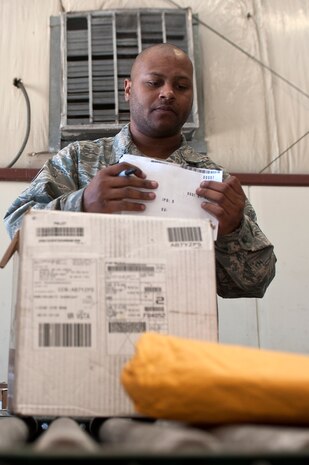 Staff Sgt. Steven Woodson, 99th Logistics Readiness Squadron inbound cargo floor supervisor, reviews cargo receiving documentation at LRS Sept. 27, 2013, at Nellis Air Force Base, Nev. Cargo specifics are listed on a DD Form 1348, Single Line Requisition Document, that provides information such as serial numbers, quantity, status, item remarks and priority level of the item. (U.S. Air Force photo by Staff Sgt. Christopher Hubenthal)