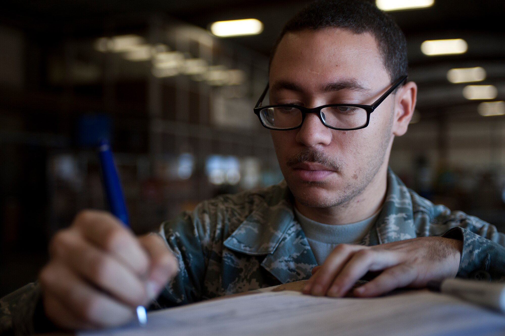 Airman 1st Class Avery Simmons, 99th Logistics Readiness Squadron outbound cargo traffic management apprentice, reviews cargo receiving documentation at LRS Sept. 27, 2013, at Nellis Air Force Base, Nev. Cargo specifics are listed on a DD Form 1348, Single Line Requisition Document, that provides information such as serial numbers, quantity, status, item remarks and priority level of the item. (U.S. Air Force photo by Staff Sgt. Christopher Hubenthal)