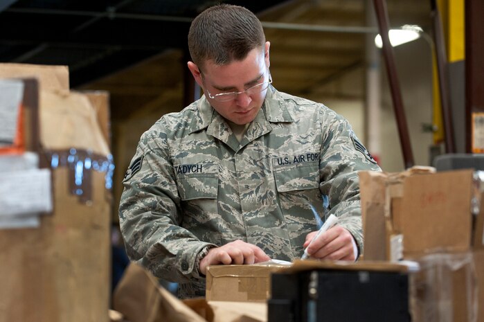Senior Airman Joseph Tadych, 99th Logistics Readiness Squadron outbound cargo traffic management journeyman, prepares cargo for movement at LRS Sept. 27, 2013, at Nellis Air Force Base, Nev. Airmen of the 99th LRS who work with cargo at Nellis AFB can prepare items for movement as small as an O-Ring to as large as an aircraft engine. (U.S. Air Force photo by Staff Sgt. Christopher Hubenthal)