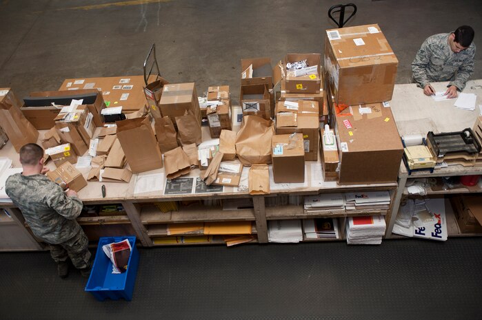 Senior Airman Joseph Tadych (left) and Senior Airman Donovan Ortiz (right), 99th Logistics Readiness Squadron outbound cargo traffic management journeymen, ensure details on the DD Form 1348s, Single Line Requisition Document, match incoming items to LRS Sept. 27, 2013, at Nellis Air Force Base, Nev. Tadych and Ortiz also ensure cargo is packed for movement and identify the best method of transportation. (U.S. Air Force photo by Staff Sgt. Christopher Hubenthal)