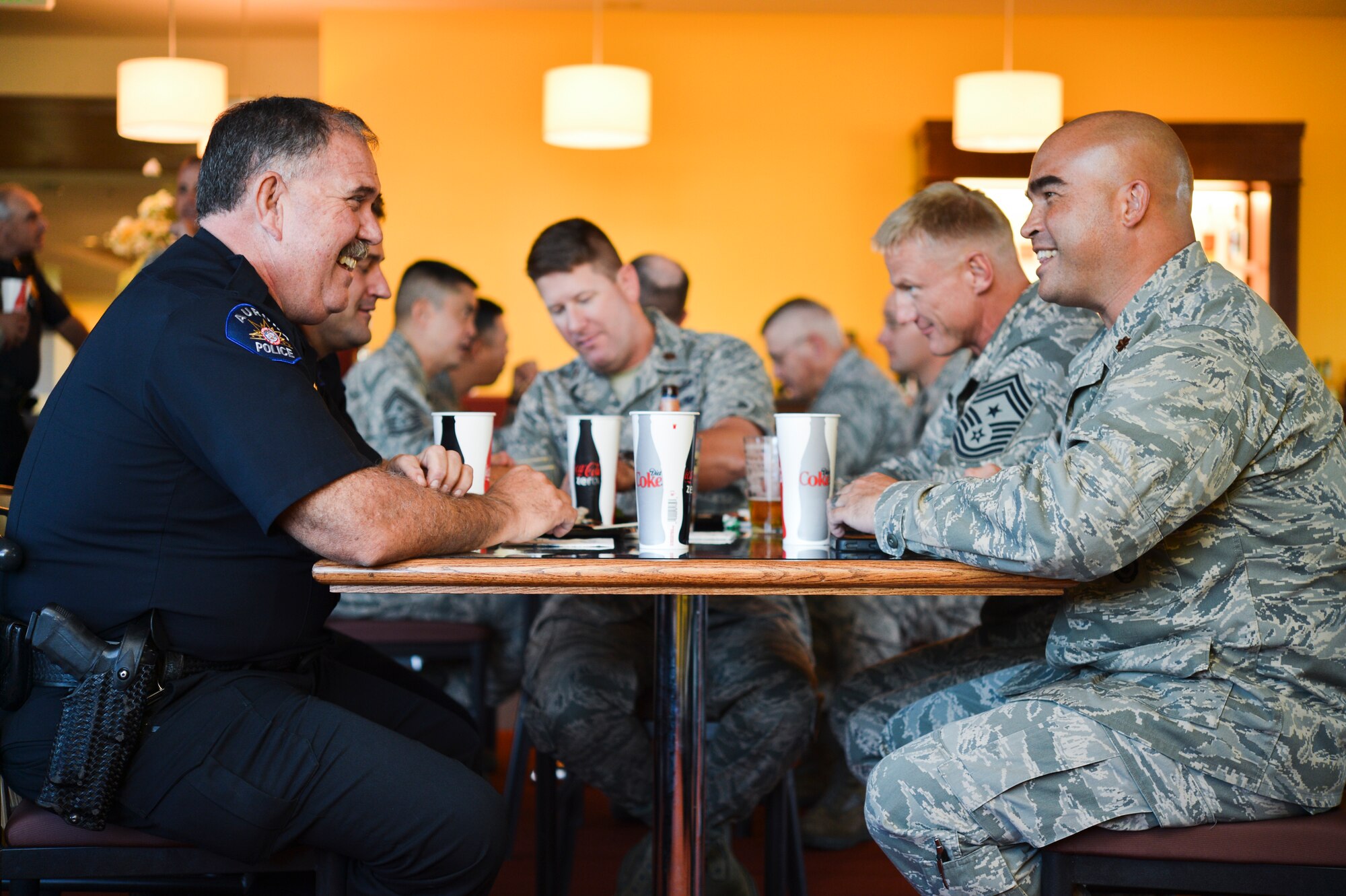 Commander Kevin Flynn, Aurora Police Department, left, visits with Maj. David Haigh, 460th Security Forces Squadron commander, Sept. 26, 2013, at the Panther’s Den during community commanders program meeting  at Buckley Air Force Base, Colo. One aim of the Co-Commander Program is to orient community members who may have limited knowledge of military operations. (U.S. Air Force photo by Staff Sgt. Paul Labbe/Released)