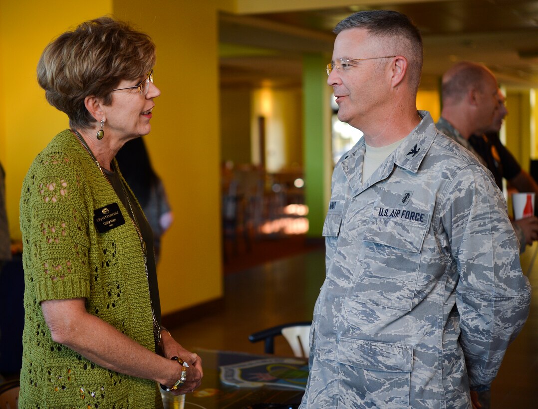 Cathy Noon, Centennial mayor, left, speaks with Col. Michael Kindt, 460th Medical Group commander, Sept. 26, 2013, at the Panther’s Den during community commanders program meeting at Buckley Air Force Base, Colo. Civilian counterparts are selected among elected officials, mayors and chamber of commerce members to be inducted into the Co-Commanders Program every two years. (U.S. Air Force photo by Staff Sgt. Paul Labbe/Released) 