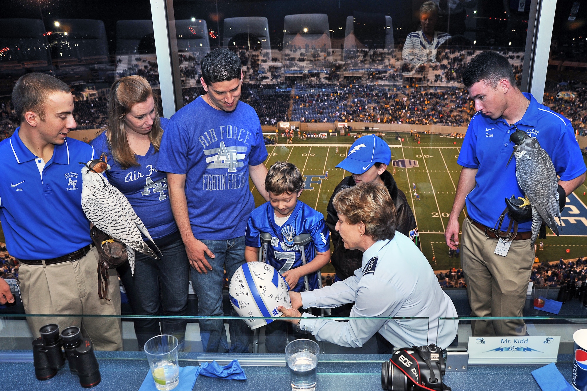 Academy Superintendent Lt. Gen. Michelle Johnson (right) gives Aubrey Aragon a Falcon football helmet, signed by the players, at the Air Force-Wyoming football game Sept. 21. (U.S. Air Force Photo/Liz Copan)