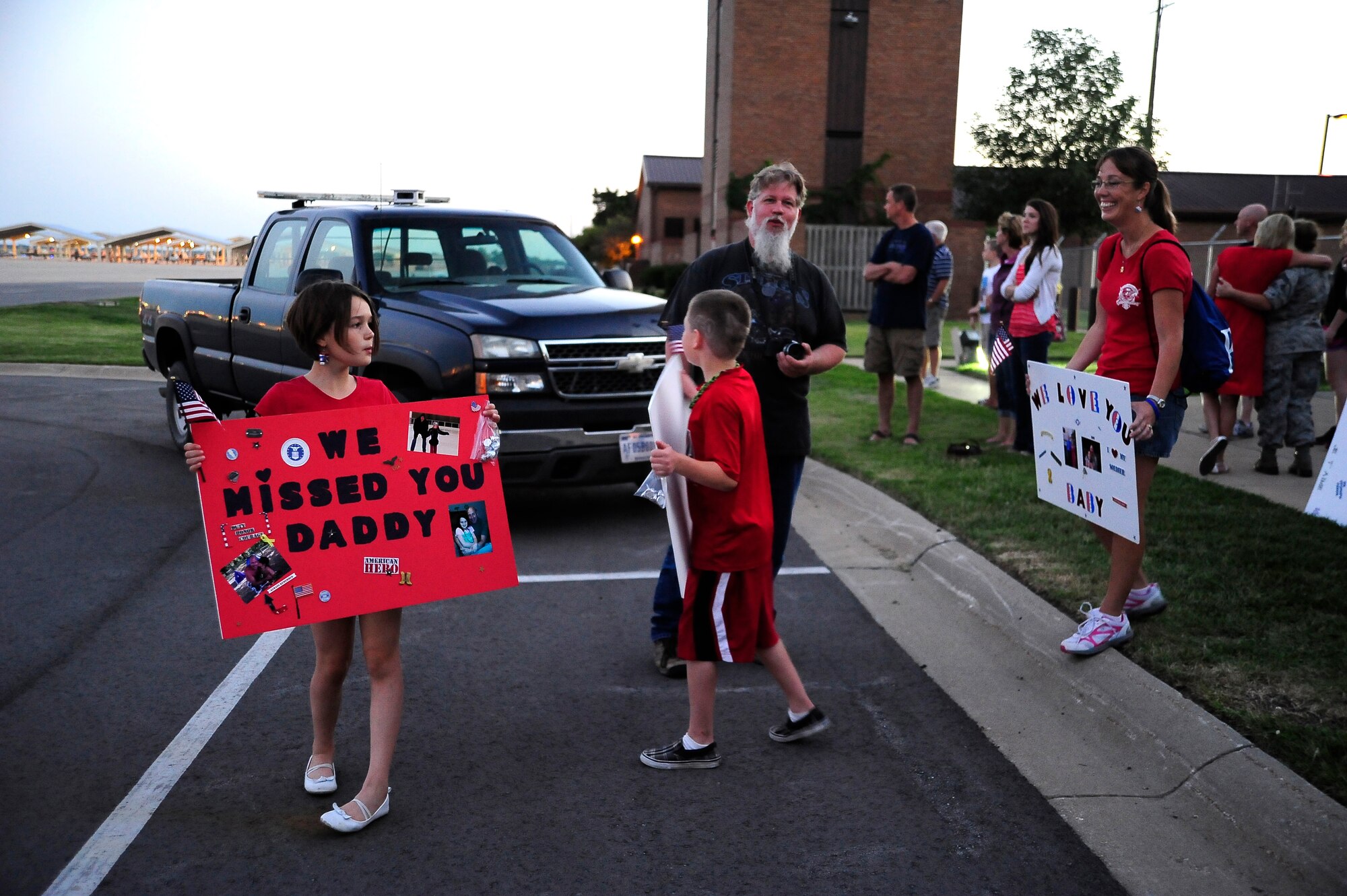 The family of U.S. Air Force Senior Airman Charles Kotcher, 442nd Security Forces Squadron, eagerly awaits his return to Whiteman Air Force Base, Mo., Sept. 27, 2013. Along with Kotcher, nearly 30 Airmen from the squadron deployed to Manas Air Base, Kyrgyzstan, to support Manas’ base defense mission.  (U.S. Air Force photo by Staff Sgt. Brigitte N. Brantley/Released)