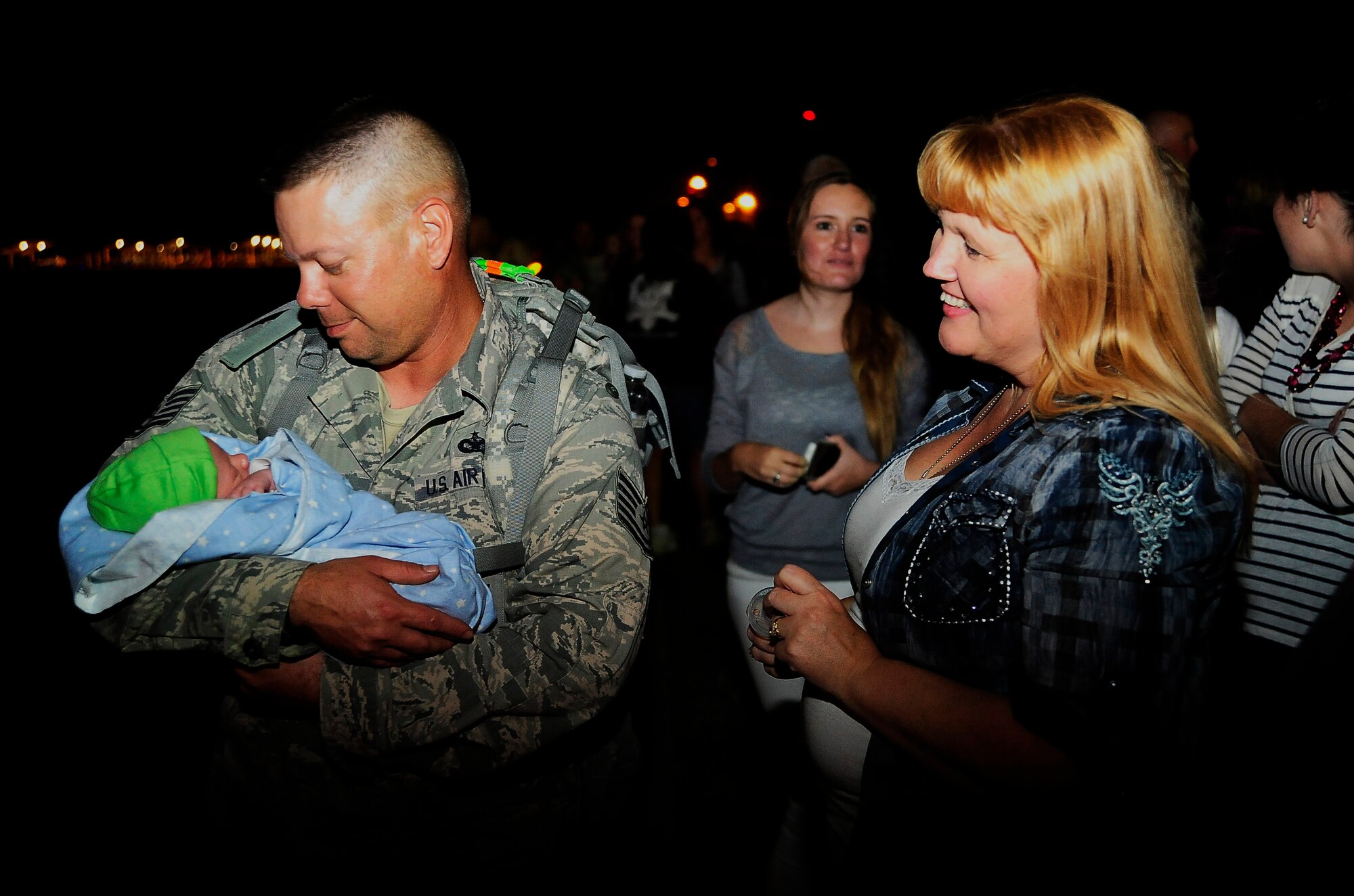 U.S. Air Force Tech. Sgt. David Dane holds his 6-day-old son Tristan for the first time at Whiteman Air Force Base, Mo., Sept. 27, 2013. Dane is assigned to the 442nd Security Forces Squadron and returned from a six-month-long deployment to Manas Air Base, Kyrgyzstan. (U.S. Air Force photo by Staff Sgt. Brigitte N. Brantley/Released)