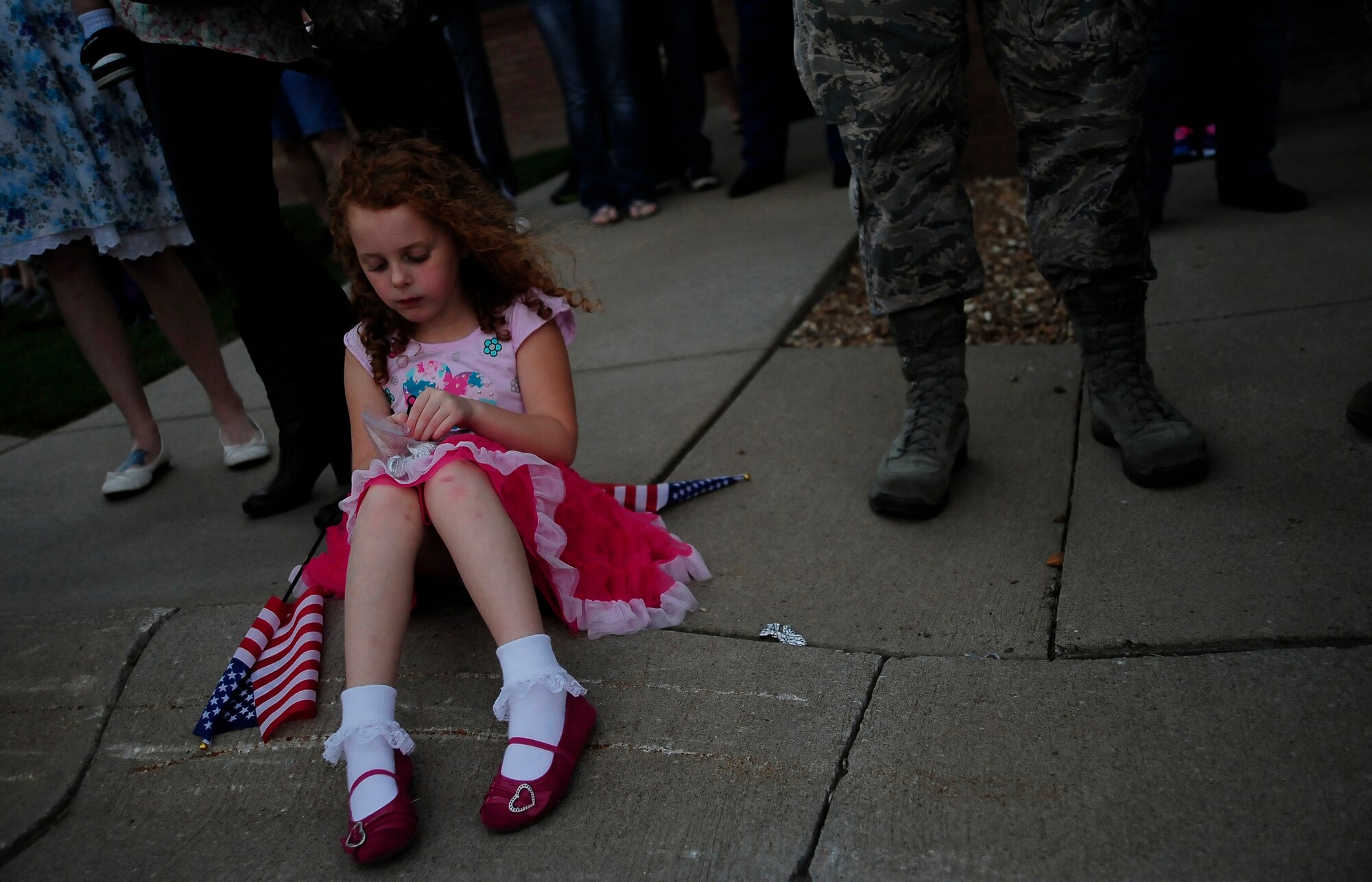Lily Ann Patterson patiently awaits the return of her father, U.S. Air Force Tech. Sgt. Travis Patterson, to Whiteman Air Force Base, Mo., Sept. 27, 2013. Sergeant Patterson, along with nearly 30 other Airmen from the 442nd Security Forces Squadron, spent six months deployed to Manas Air Base, Kyrgyzstan. (U.S. Air Force photo by Staff Sgt. Brigitte N. Brantley/Released)