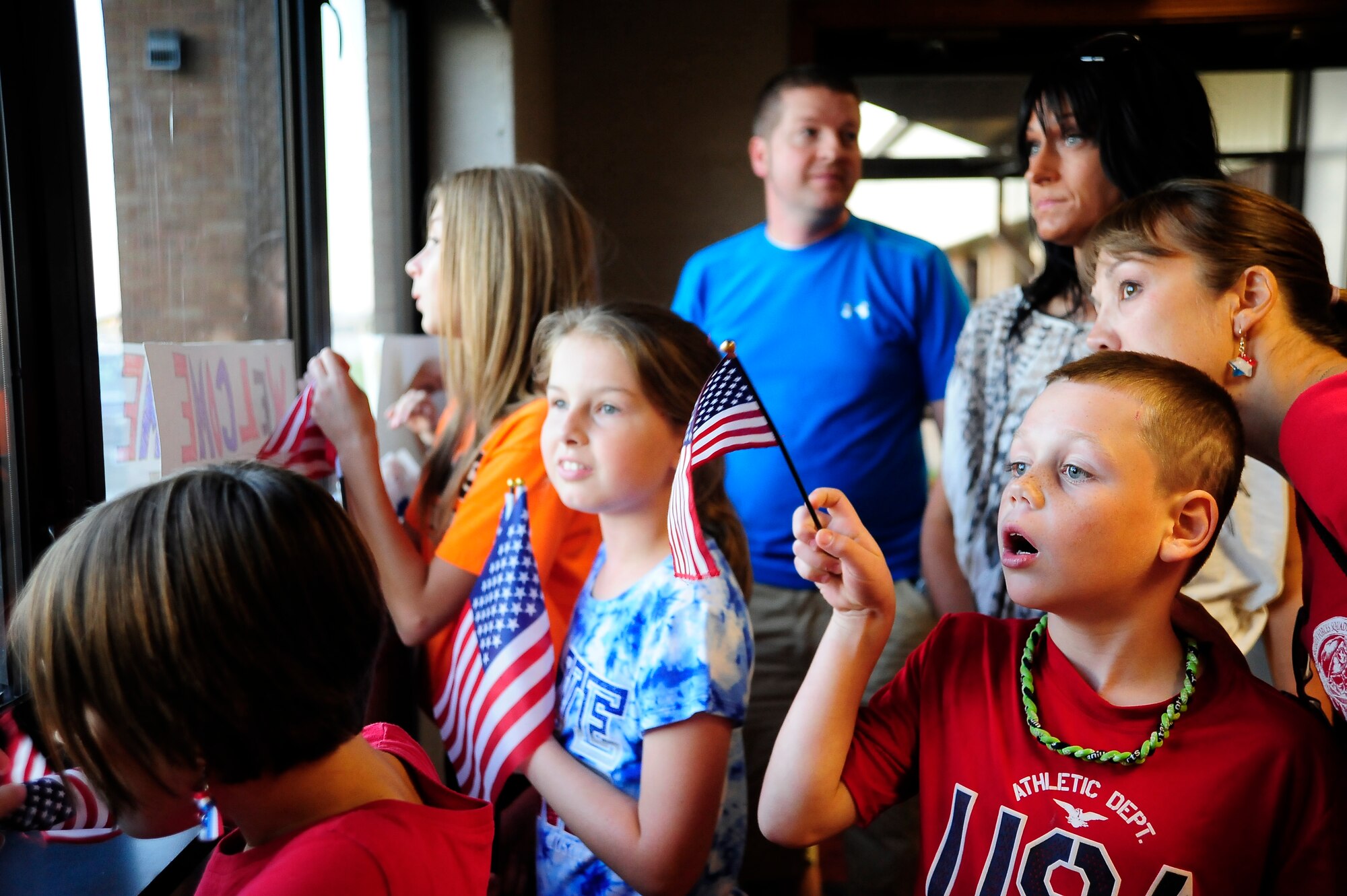 Family members and friends of Airmen from the 442nd Security Forces Squadron eagerly await their arrival at Whiteman Air Force Base, Mo., Sept. 27, 2013. During their six-month deployment to Manas Air Base, Kyrgyzstan, the Airmen’s main mission was base defense. (U.S. Air Force photo by Staff Sgt. Brigitte N. Brantley/Released)