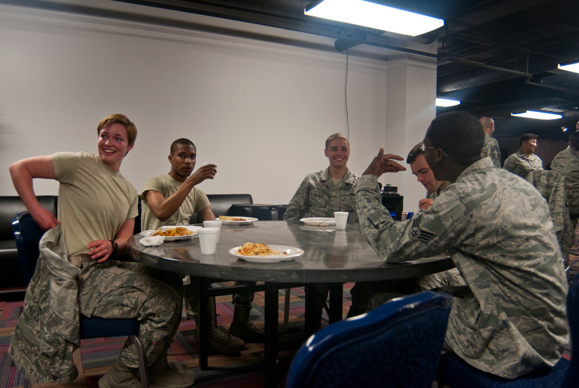 Airmen who live in F.E. Warren Air Force Base, Wyo., dormitories eat at dinner hosted by 90th Missile Wing Chapel personnel Sept. 25, 2013, in the Fall Hall Community Center. Chapel personnel team up each month with a different base organization to host a dorm dinner for Airmen who live in base dormitories. It provides the Airmen with a chance to get out of the dorms and socialize with their peers. The 90th Security Forces Group worked with the chapel to host this dorm dinner. (U.S. Air Force photo by Airman 1st Class Jason Wiese)