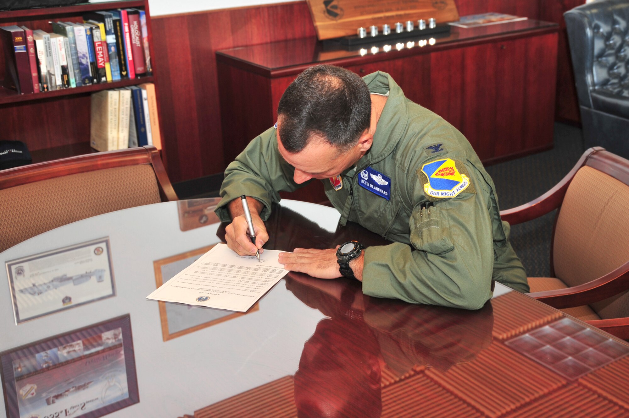 U.S. Air Force Col. Kevin E. Blanchard, 355th Fighter Wing commander, signs a Domestic Violence Awareness Proclamation at Davis-Monthan Air Force Base, Ariz., Sept. 27, 2013. The proclamation states that one in three Americans have witnessed an incident of domestic violence. (U.S. Air Force photo by Airman 1st Class Josh Slavin/Released)
