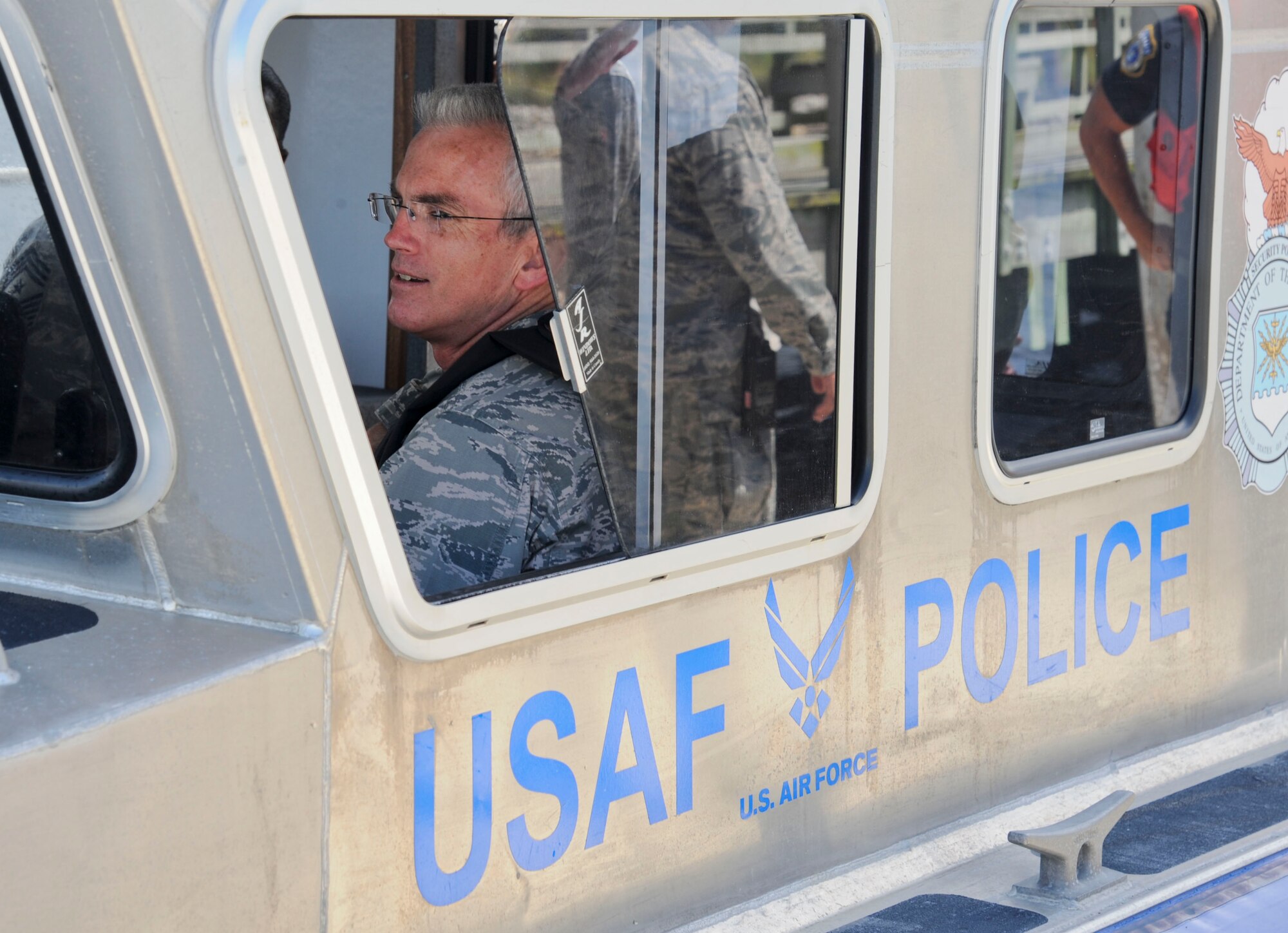 Gen. Paul Selva, Air Mobility Command commander, sits behind the wheel of a marine patrol boat with Airmen of the 6th Security Forces Squadron at MacDill Air Force Base, Fla., Sept. 26, 2013. Selva was taken out with the marine patrol for a tour of MacDill from Tampa Bay. (U.S. Air Force photo by Airman 1st Class Ned T. Johnston/Released) 