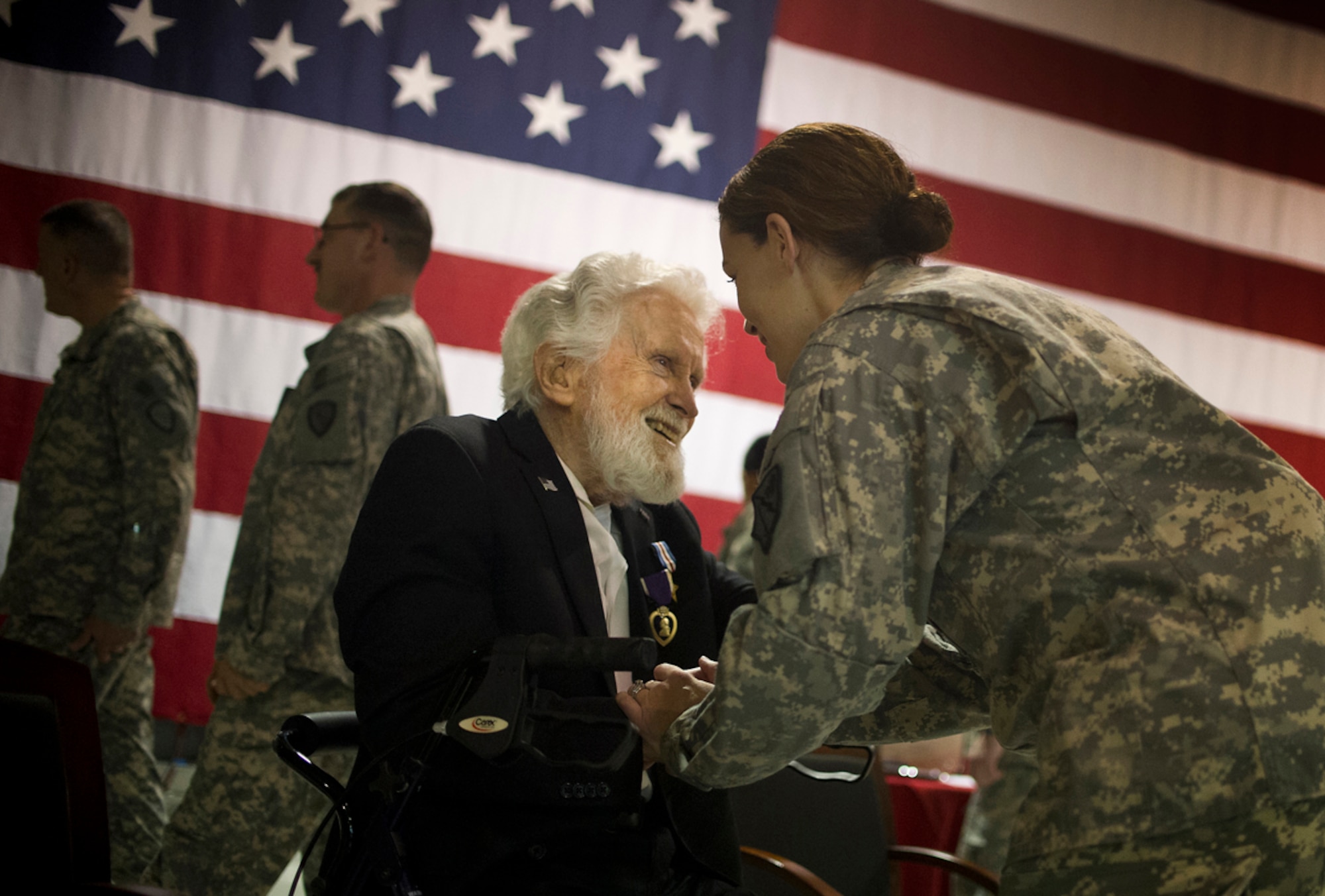 World War II veteran Arthur W. Owens shares a private moment with an Alaska Army National Guard soldier after being awarded the Silver Star and Purple Heart 68 years after his heroic actions while fighting near Ludwigshafen, Germany. On March 23, 1945, Owens' tank was hit by a shell from an anti-tank gun.  After evacuating the vehicle, he returned twice under heavy enemy fire -- and despite his wounds -- to rescue injured comrades. After a review of his records, Secretary of the Army John McHugh recently signed orders to recognize Owens. Brig. Gen. Mike Bridges, commander of the Alaska Army National Guard, presented the medals during a ceremony at the Alaska National Guard headquarters on Joint Base Elmendorf-Richardson, Thursday, Sept. 19, 2013. (U.S. Air Force photo by Justin Connaher/Released)