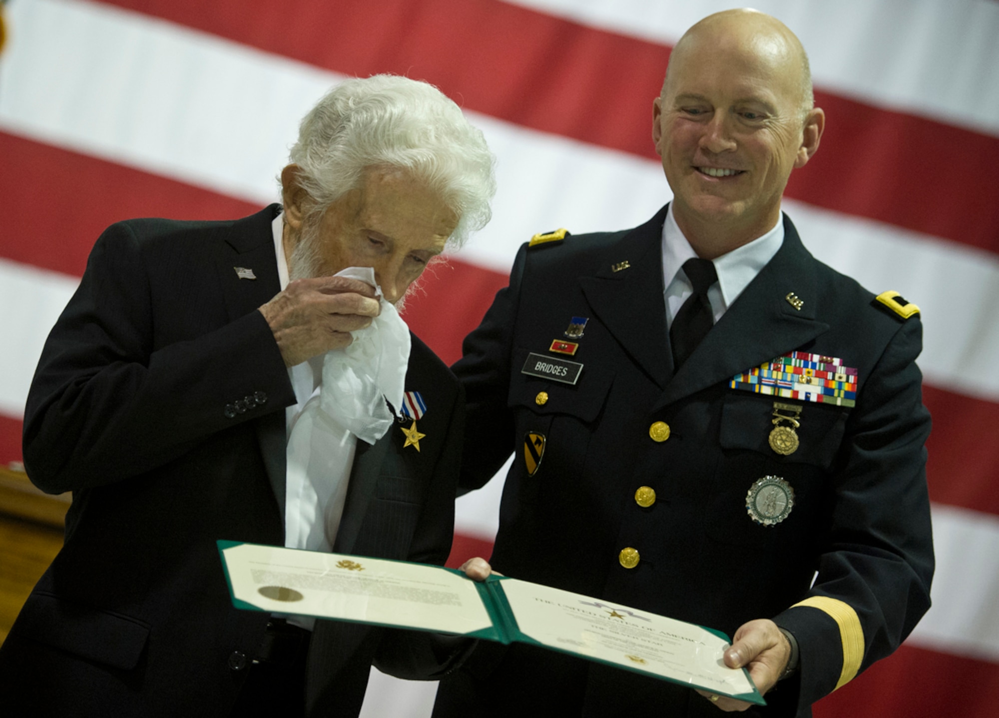 World War II veteran Arthur W. Owens shows emotion as he is awarded the Silver Star and Purple Heart 68 years after his heroic actions while fighting near Ludwigshafen, Germany. On March 23, 1945, Owens' tank was hit by a shell from an anti-tank gun.  After evacuating the vehicle, he returned twice under heavy enemy fire -- and despite his wounds -- to rescue injured comrades. After a review of his records, Secretary of the Army John McHugh recently signed orders to recognize Owens. Brig. Gen. Mike Bridges, commander of the Alaska Army National Guard, presented the medals during a ceremony at the Alaska National Guard headquarters on Joint Base Elmendorf-Richardson, Thursday, Sept. 19, 2013. (U.S. Air Force photo by Justin Connaher/Released)