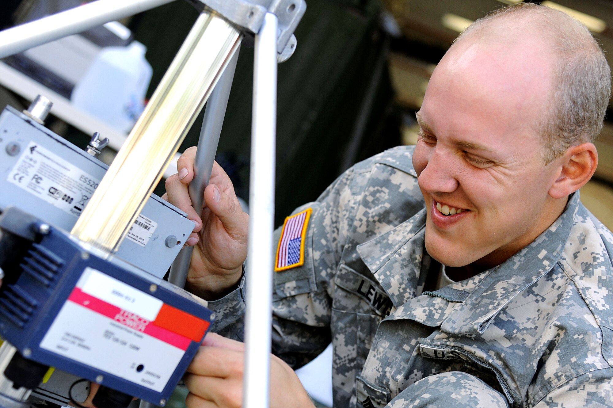 U.S. Army Sgt. Ryan Lewis, 689th Rapid Port Opening Element, 833rd Transportation Battalion movement noncommissioned officer, works on a transportation relay system at Fort Eustis, Va., Sept. 12, 2013. Lewis won the 2013 Army Materiel Command Soldier of the Year competition. (U.S. Air Force photo by Airman 1st Class Austin Harvill/Released)