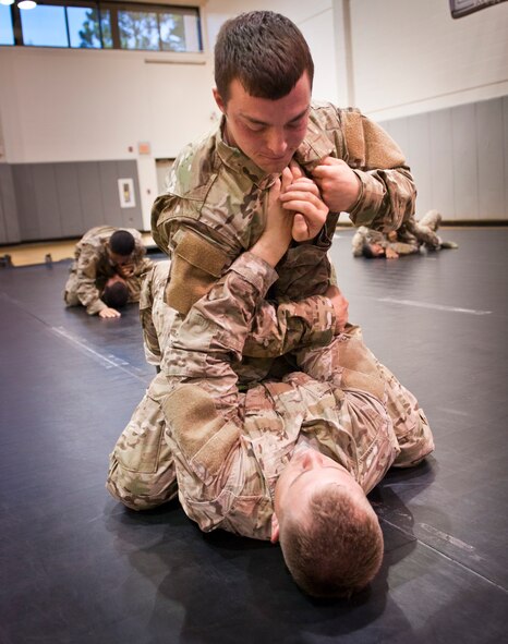 Tactical Air Control Party candidates practice an arm bar during combative skills training at the Aderholt Fitness Center on Hurlburt Field, Fla., Sept. 17, 2013. At this point the candidates were four months into their technical training. (U.S. Air Force photo/Senior Airman Krystal M. Garrett)