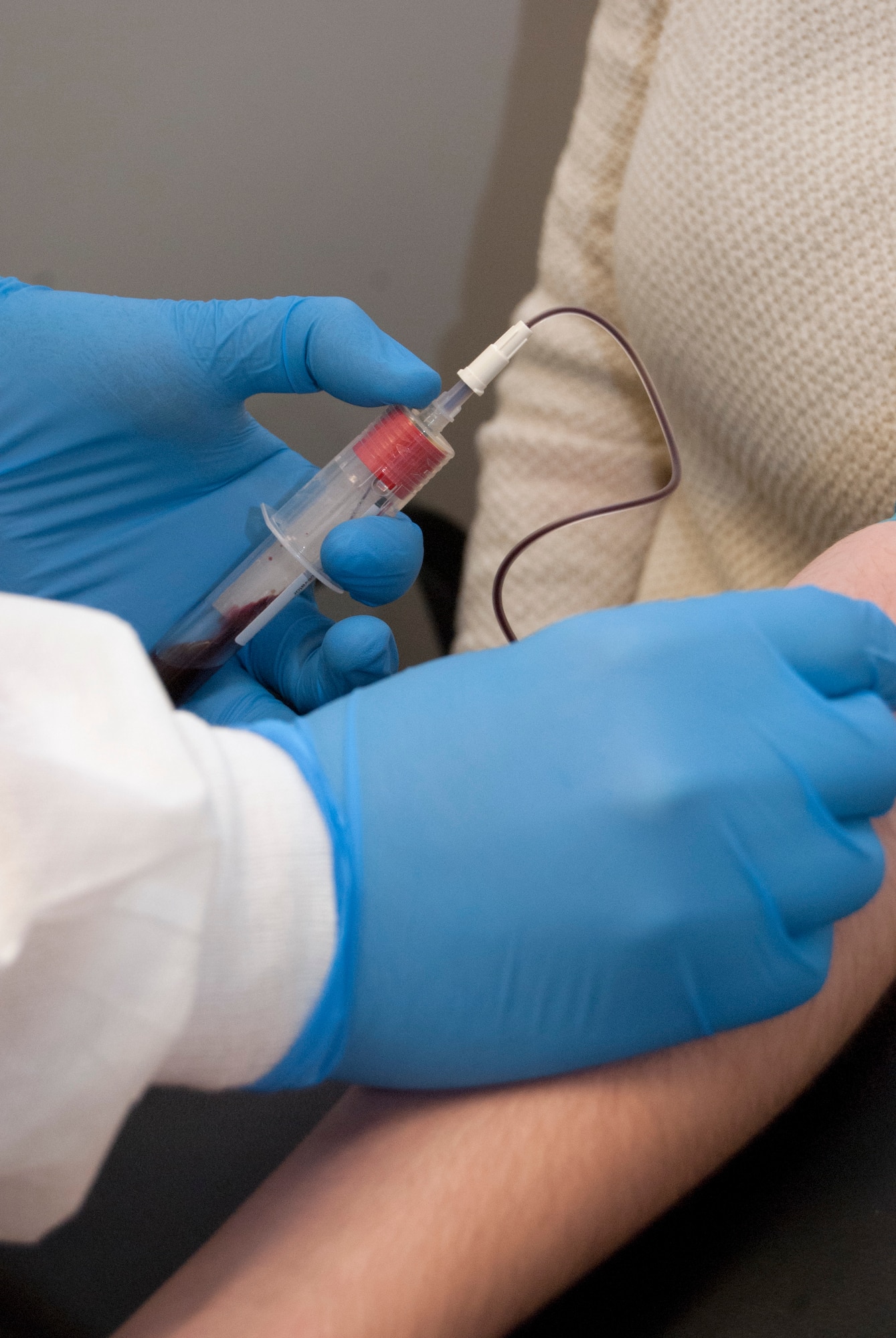 Senior Airman Brent Erolla draws blood from a patient in the 10th Medical Group Clinic at the Air Force Academy Sept. 25, 2013. The Academy's lab was named the best in the country in the April 2013 issue of Advance Magazine, a trade periodical serving medical professionals. Erolla is a lab technician with the 10th Medical Support Squadron. (U.S. Air Force photo/Don Branum)