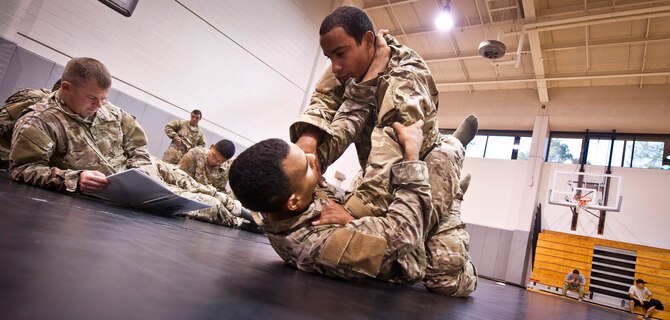 Tactical Air Control Party candidates practice an arm bar during combative skills training at the Aderholt Fitness Center on Hurlburt Field Fla., Sept. 17, 2013. The candidates went through a five-day combative training course as a part of their technical training. (U.S. Air Force photo/Senior Airman Krystal M. Garrett)