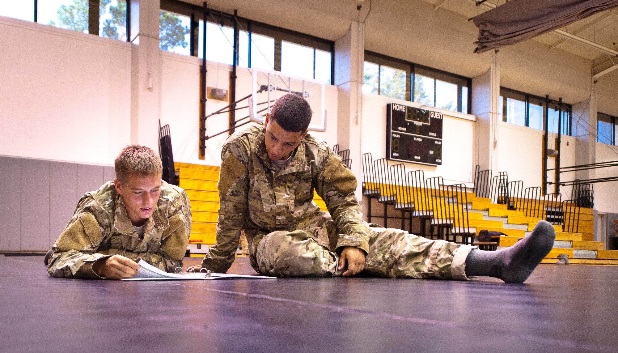 Tactical Air Control Party candidates read a combative skills training manual prior to practicing combative skills at the Aderholt Fitness Center on Hurlburt Field, Fla., Sept. 17, 2013. At this point the candidates were four months into their technical training. (U.S. Air Force photo/Senior Airman Krystal M. Garrett)
