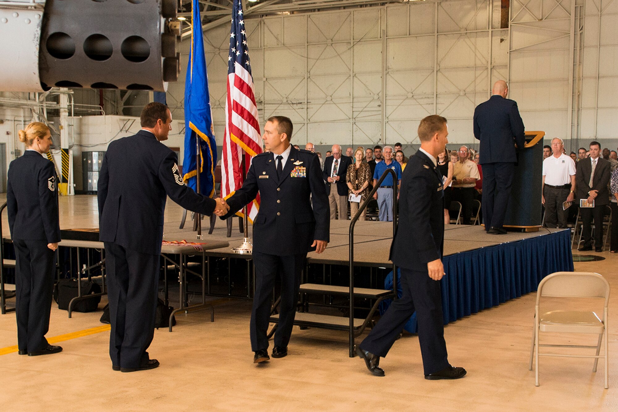 U.S. Air Force Col. John Breazeale, 917th Fighter Group commander, shakes hands with Chief Master Sgt. Cary Johnson, as he leaves the stage following the Inactivation Ceremony of the fighter group, Sept. 26, 2013, Barksdale Air Force Base, La. The ceremony officially ended the 50 year presence of the 917th at Barksdale. (U.S. Air Force photo by Master Sgt. Greg Steele/Released)