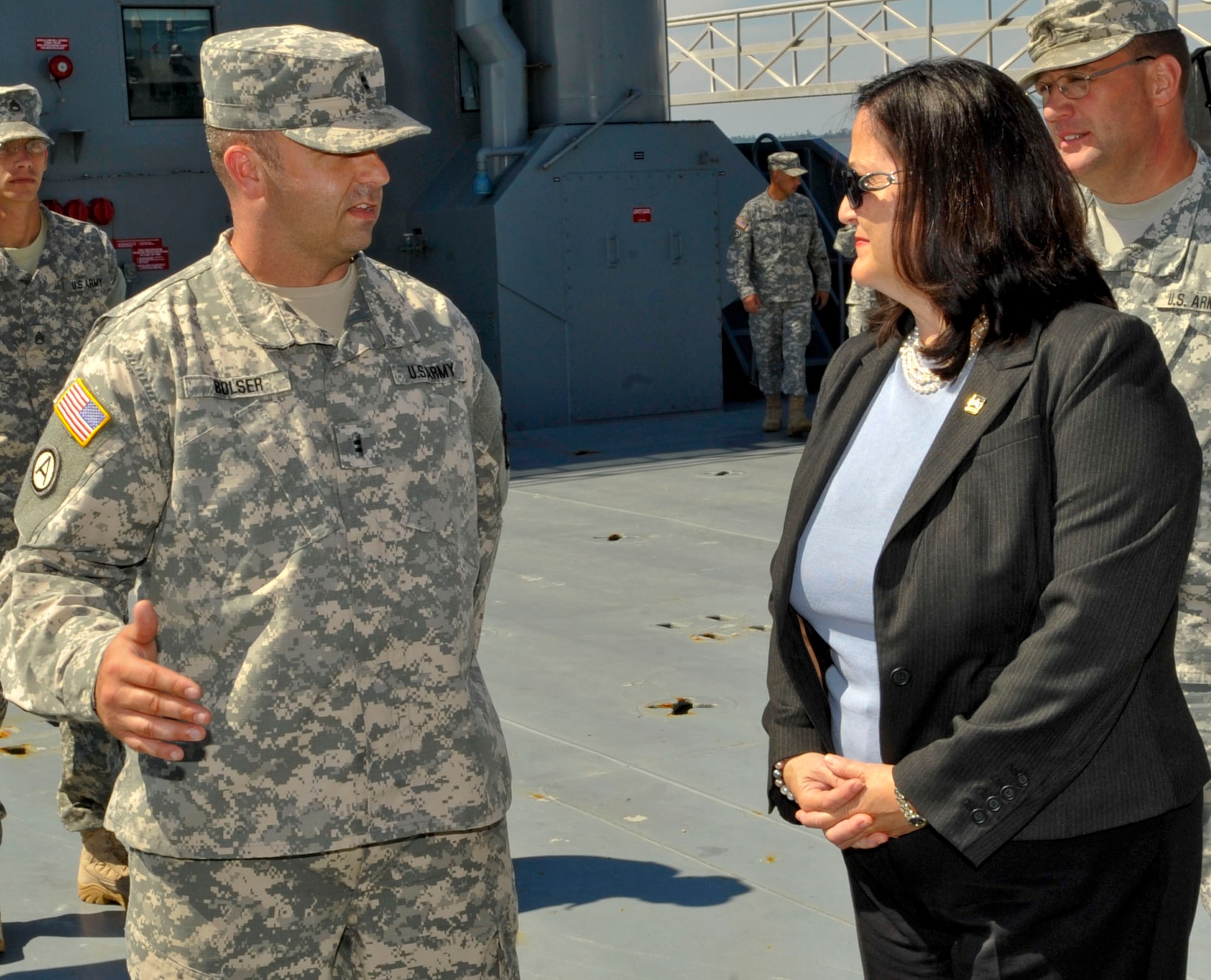 U.S. Army Chief Warrant Officer 2 Gary Bolser, 97th Transportation Company Landing Craft Utility 2000 vessel master, briefs Katherine Hammack, Assistant Secretary of the Army for Installations, Energy & Environment, about the capabilities of his vessel during a tour at Fort Eustis, Va., Sept. 25, 2013. Hammack visited several locations, talked to Soldiers about their jobs and toured post facilities. (U.S. Air Force photo by Staff Sgt. Wesley Farnsworth/Released)