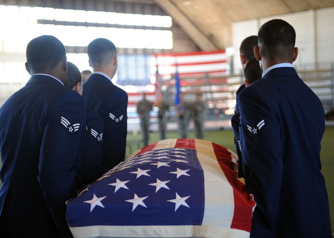 Honor guard trainees transport a casket during an honor guard training course in the Pride Hangar at Ellsworth Air Force Base, S.D. Sept. 19, 2013. Ellsworth Honor Guard members participate in nearly 150 funeral services a year throughout South Dakota, Nebraska and Wyoming. (U.S. Air Force photo by Airman 1st Class Rebecca Imwalle/Released)