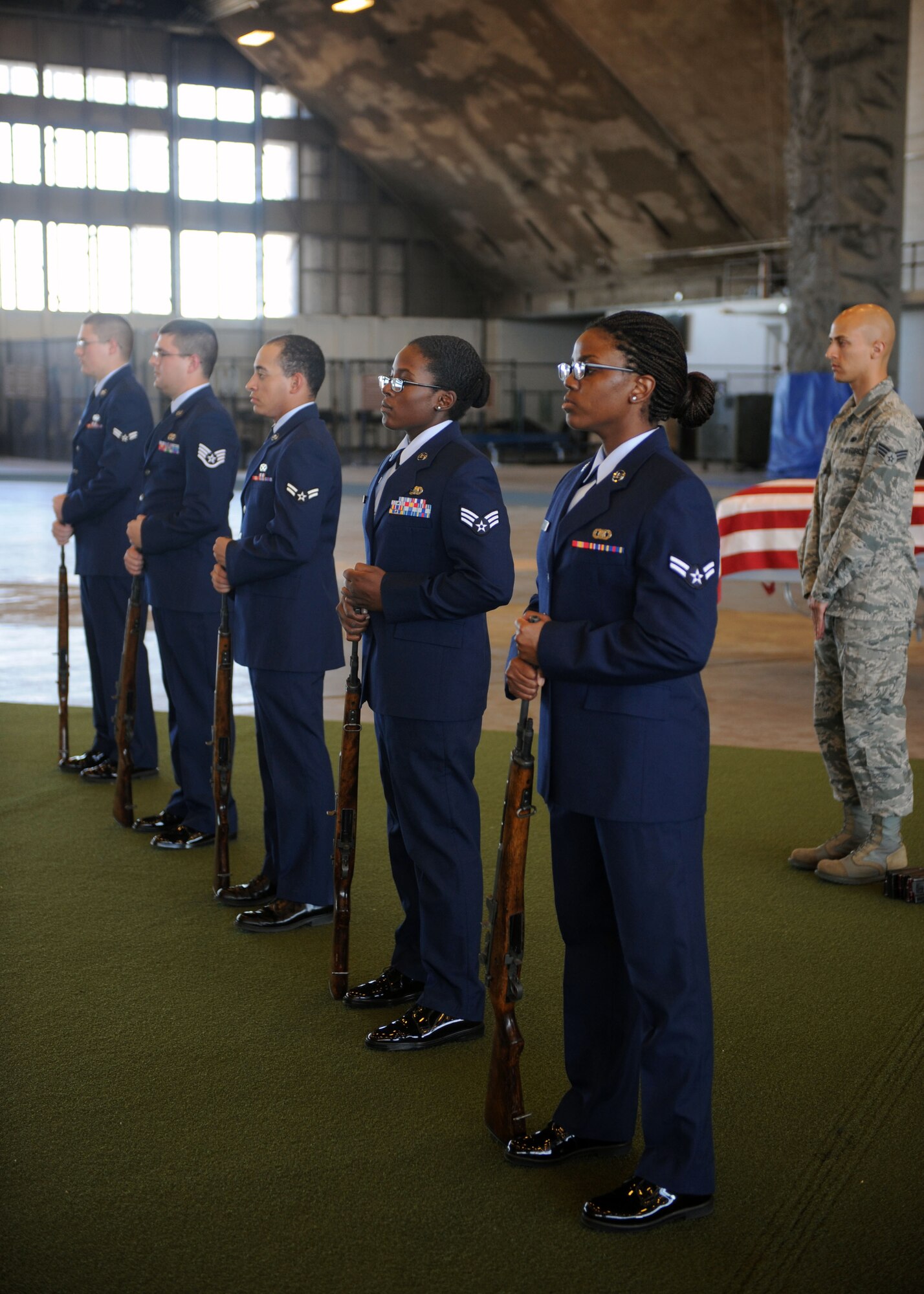 Honor guard trainees are evaluated on firing party movements during the final inspection of an honor guard training course in the Pride Hangar at Ellsworth Air Force Base, S.D. Sept. 19, 2013. Ellsworth Honor Guard instructors conduct a final inspection on the fifth day of training, in an effort to ensure trainees are proficient in all aspects of a funeral ceremony. (U.S. Air Force photo by Airman 1st Class Rebecca Imwalle/Released)