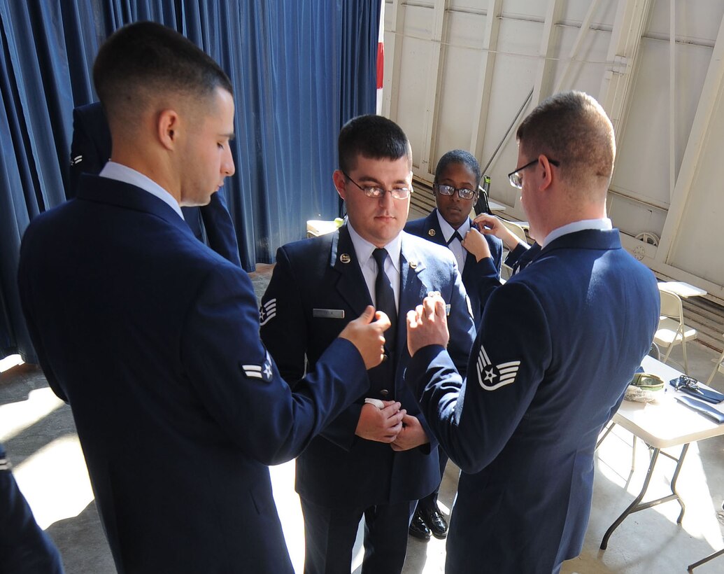Honor Guard trainees inspect each other’s uniforms during an honor guard training course in the Pride Hangar at Ellsworth Air Force Base, S.D. Sept. 19, 2013. Trainees are inspected in their service dress uniform as a part of the final test during honor guard training, ensuring their dress and appearance represent the Air Force’s highest standards. (U.S. Air Force photo by Airman 1st Class Rebecca Imwalle/Released)