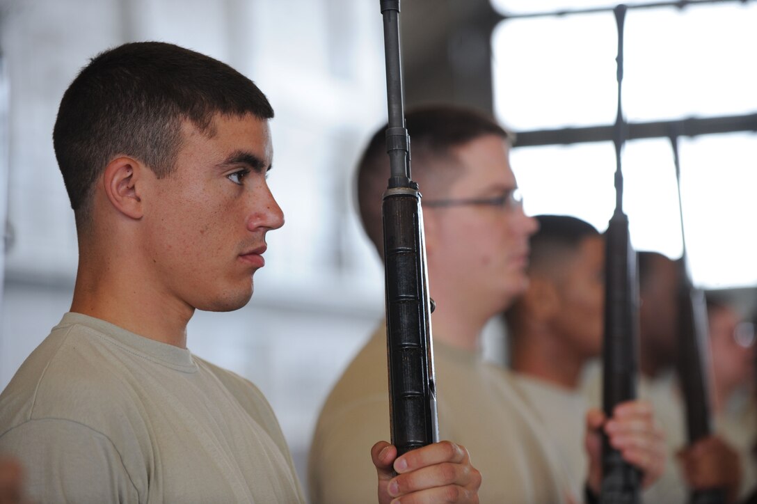 Senior Airman Joshua Jordan, 28th Logistics Readiness Squadron fuels facilities operator, holds a rifle at port arms during honor guard training in the Pride Hangar at Ellsworth Air Force Base, S.D. Sept. 19, 2013. Jordan was one of 15 Airmen who participated in a five-day training course designed to teach trainees basic honor guard procedures. (U.S. Air Force photo by Airman 1st Class Rebecca Imwalle/Released)