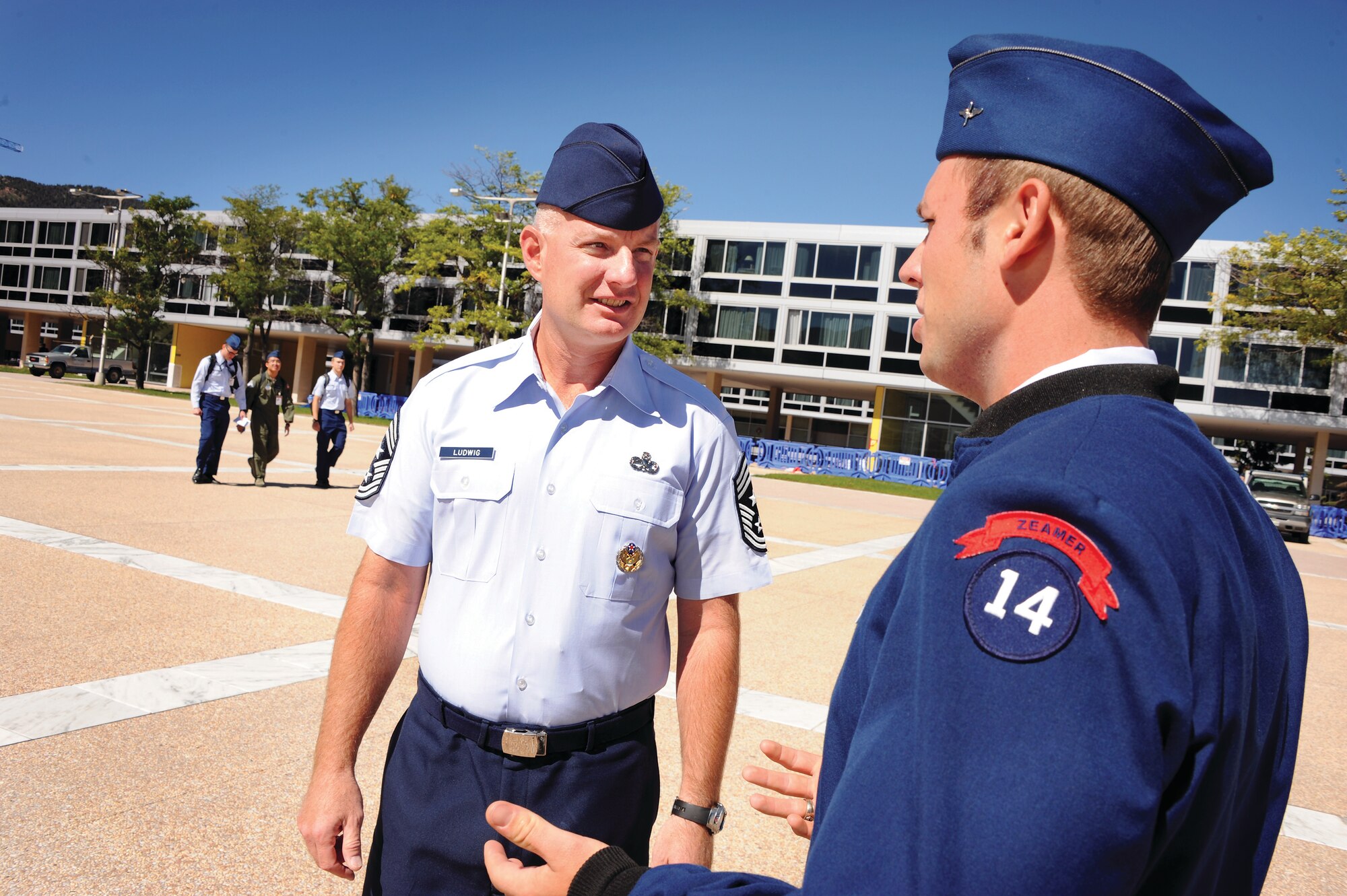 Chief Master Sgt. Stephen Ludwig, the Academy's command chief, chats with Cadet 1st Class Aaron Henrichs on the Terrazzo Wednesday. Ludwig says it's important for the Academy's enlisted Airmen to form working relationships with cadets. (U.S. Air Force Photo/Carol Lawrence)
